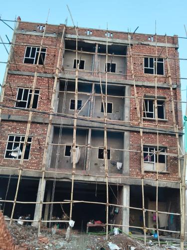 a building under construction with scaffolding around it at हर्षवाणी होम स्टे Harshvanee Home Stay in Lucknow