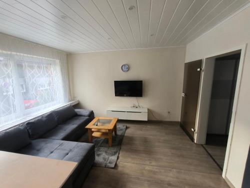 a living room with a couch and a tv at Mego in Werne an der Lippe