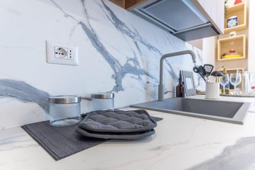 a kitchen counter with a sink and a towel at Dimora delle Vittorie - Vaticano in Rome
