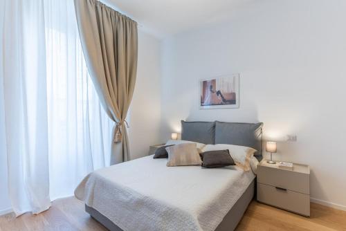 a bedroom with a bed and a large window at Dimora delle Vittorie - Vaticano in Rome