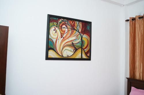 a painting of a woman on a wall at Ovenmin Villa in Haburugala