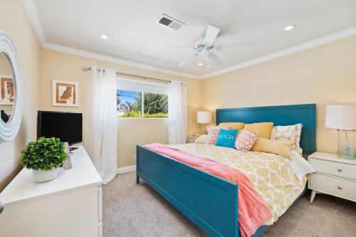 a bedroom with a blue bed and a window at Villa LaQuinta Free Pool Heating RV Parking at Point Happy in La Quinta