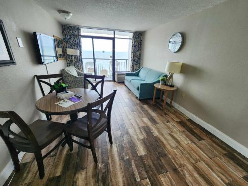 a living room with a table and a couch at Landmark 1134 in Myrtle Beach