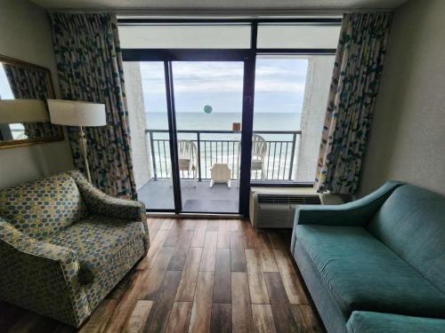 a living room with a couch and a view of the ocean at Landmark 1134 in Myrtle Beach