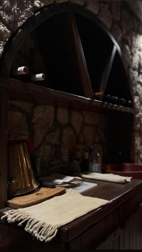a counter with a mirror and a table with a table sidx sidx sidx at Epavlis Meteora Suites Hotel in Kalabaka