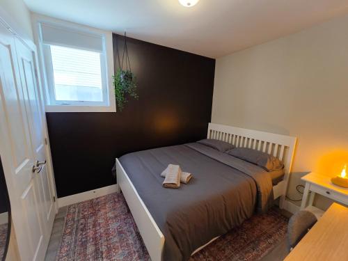 a bedroom with a bed with a towel on it at Sandy Hill Downtown Guesthouse in Ottawa