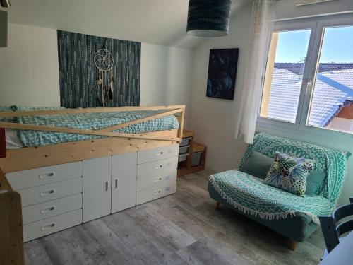 a bedroom with a bunk bed and a chair at Small mountain paradise with pool and hot tub in Marthod
