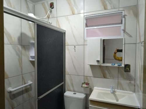 a bathroom with a sink and a toilet and a mirror at el jack in São Gabriel