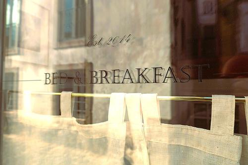 a window with the words bed and breakfast on it at Sintra1012 Boutique Guesthouse in Sintra