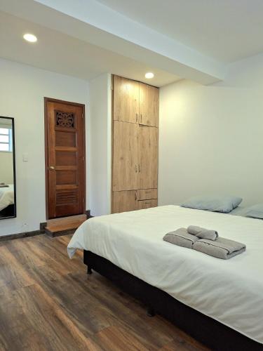 a bedroom with a bed with two towels on it at Casa Muntú - La Candelaria in Bogotá