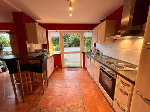 a kitchen with a counter and a stove top oven at Cattle Barn - leben auf dem Hof in Tröndel