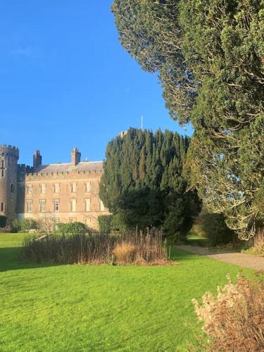 a large building with a green field and trees at Castle Wing Barmeath Estate in Dunleer
