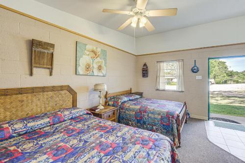 a bedroom with two beds and a ceiling fan at Hike, Fish and More Quaint Lake Whitney Retreat in Whitney