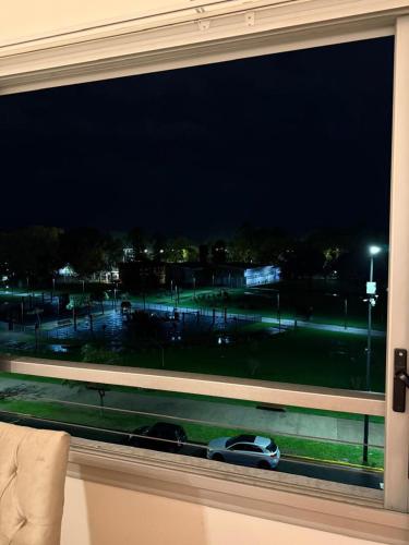 a window with a car in a parking lot at night at Onixdelujo in Buenos Aires