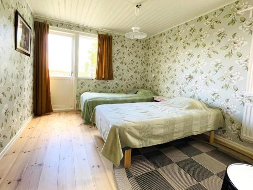 a bedroom with two beds and a window at 4 person holiday home in UDDEVALLA in Uddevalla