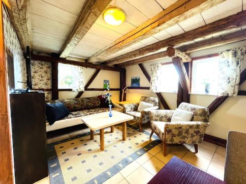 a living room with a couch and chairs and a table at 4 person holiday home in UDDEVALLA in Uddevalla