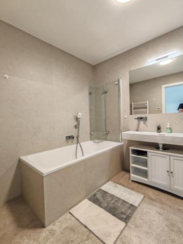 a bathroom with a large tub and a sink at Danube Refugium in Vienna