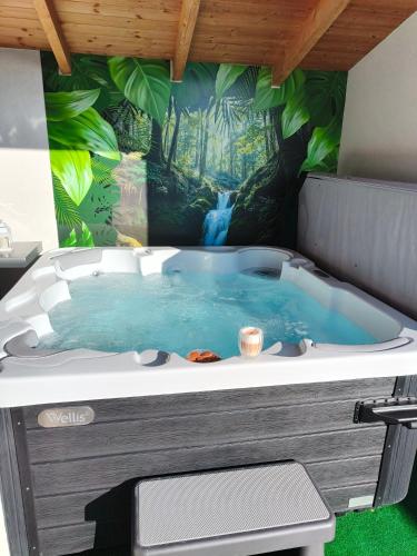 a jacuzzi tub with a painting of a waterfall at Panoráma Vendégház Jásd in Jásd