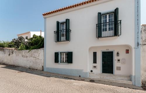 a white house with black windows and a door at Villa Sesta in Vila de Frades