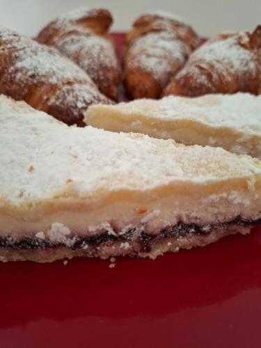 a piece of cake with powdered sugar on a red plate at Podere Radici - Room & Breakfast in Misano Adriatico