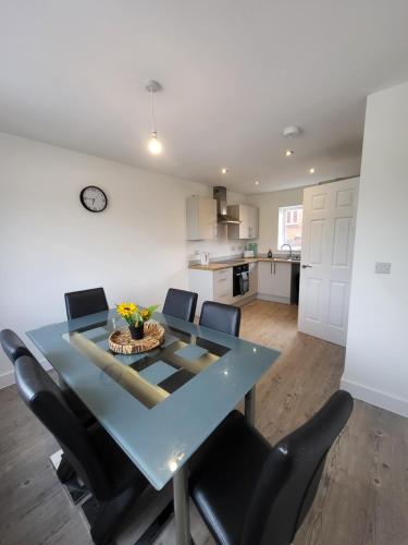 a dining room with a blue table and chairs at Kimberworth Family Stay in Kimberworth