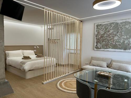 a bedroom with a bed and a glass table at El Doce Del Ferial in Solares