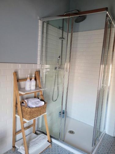 a shower in a bathroom with a glass shower stall at El Corral de la Higuera in Campofrío