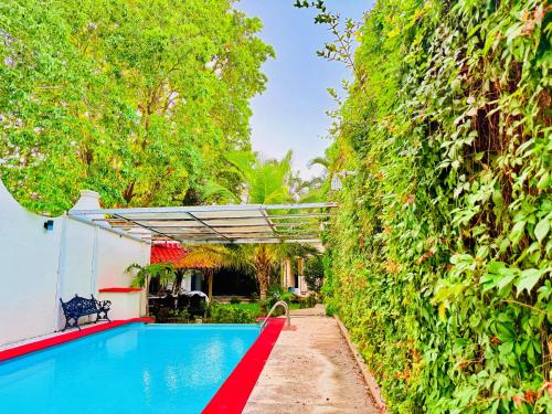 a swimming pool in front of a house at Casa Jalisco, Campeche 1 in Campeche