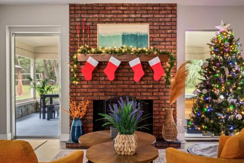a living room with a christmas tree and a fireplace at Winter Special Near Springs Spa Game Room Yard Spa EV in Crystal River