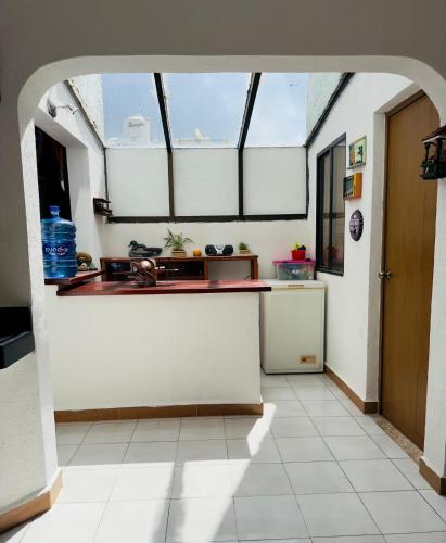 a kitchen with a sink and a counter in a room at La Casa del Capi in Cancún