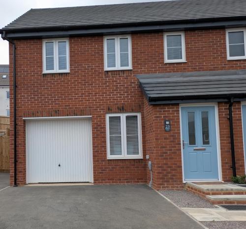 a red brick house with two garage doors at Rossetti in Bristol