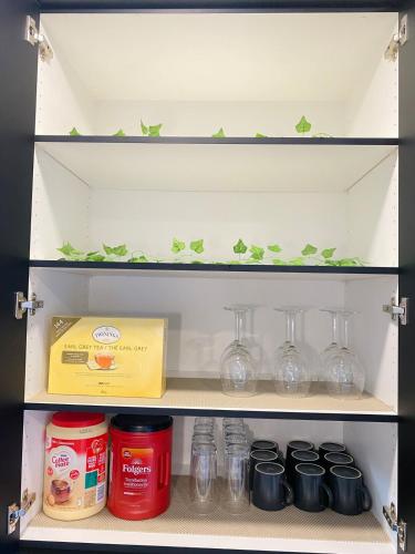 a shelf in a refrigerator filled with glass jars at NEW Luxury Family Friendly Entire House Near Downtown WEM, 3 Bedrooms in Edmonton