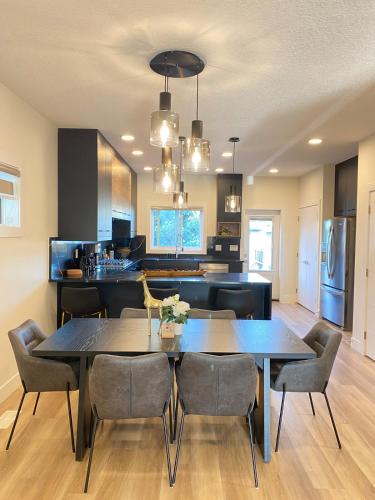 a kitchen and dining room with a table and chairs at NEW Luxury Family Friendly Entire House Near Downtown WEM, 3 Bedrooms in Edmonton