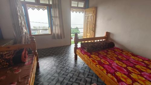 Ένα ή περισσότερα κρεβάτια σε δωμάτιο στο Gyabak homestay, Kaffergaon, Kalimpong