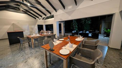 a dining room with a table and chairs at Mopani Lodge Victoria Falls in Victoria Falls
