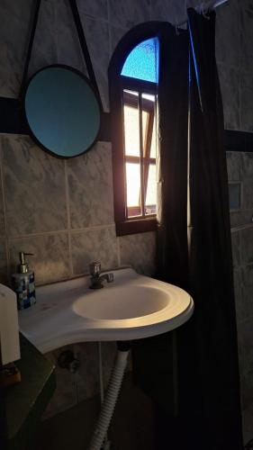 a bathroom with a sink and a window at RustiCity in São Paulo