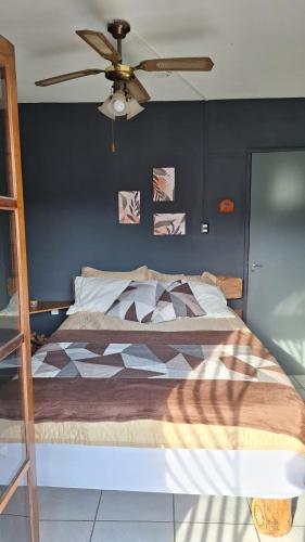 a bedroom with a bed with a ceiling fan at RustiCity in São Paulo