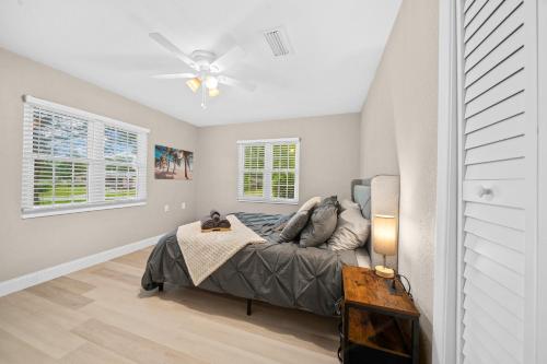 a bedroom with a bed and a ceiling fan at Relaxing, Cozy 3BR Pool Home with King Suite! in Ocala