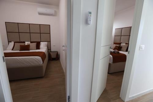 a hotel room with two beds and a couch in it at Residence Costa dei gigli 2 in Simeri Mare