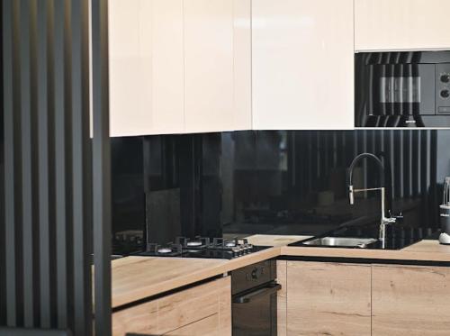 a kitchen with white cabinets and a sink and a stove at Bjelašnica Ski View Apartment in Bjelašnica
