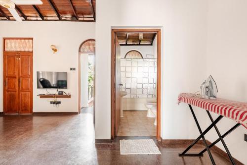 a hallway with a bathroom with a toilet and a television at The Samdro Colombo in Colombo