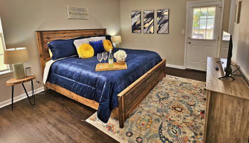 a bedroom with a bed and a table with glasses on it at Lg Deck-BBQ Grill - King Suite - Near RAFB in Bonaire