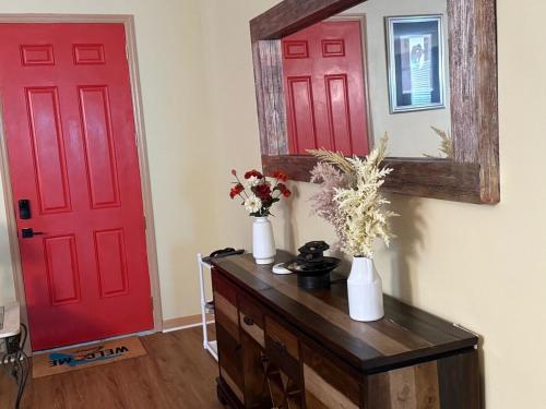 a room with two red doors and a mirror at Magic Stay 4-Bedroom Home Close to Disney in Kissimmee