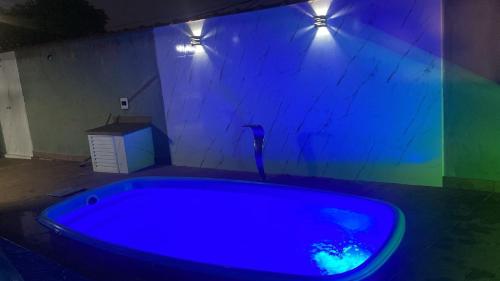 a blue bath tub in a room with lights at J Morelli s - A 2 Minutos dos Melhores Parques de Olímpia in Olímpia