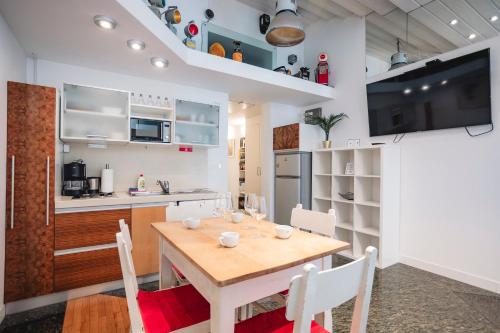 a kitchen and dining room with a wooden table and chairs at LightBox Central in Ljubljana
