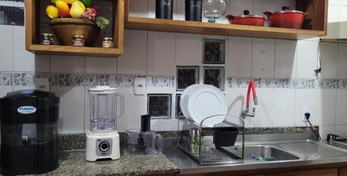 a kitchen counter with a blender and a sink at Dream House in Ananindeua