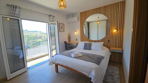 Un dormitorio con una cama con espejo y una ventana. en Top Floor in Flor do Campo - Santana, en Santana