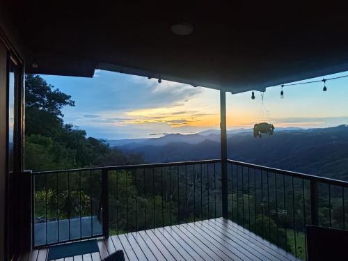 a view from the balcony of a house with the sunset at Casa Amanecer & Atardecer in Nandayure