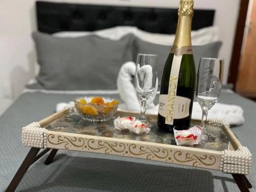 una bottiglia di champagne e bicchieri su un tavolo di Chalé Beira Rio Cipó a Serra do Cipo