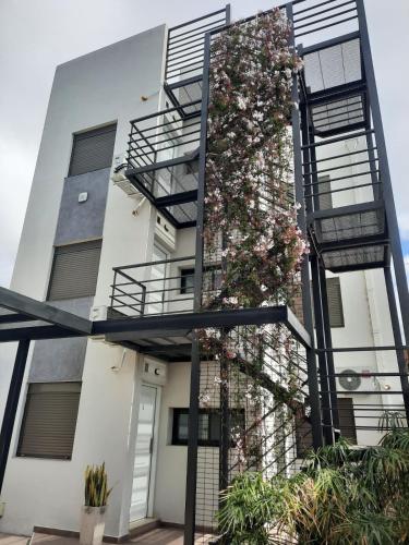a building with a staircase with flowers on it at COMPLEJO CRUZ in Alta Gracia